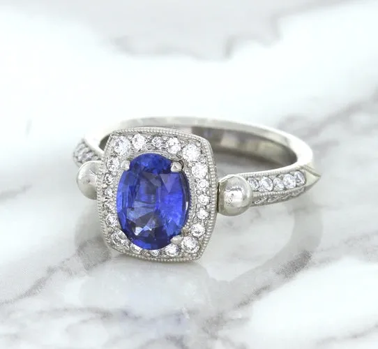 1.56ct Oval Blue Sapphire Ring with Diamond Halo in Platinum