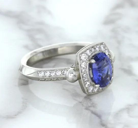1.56ct Oval Blue Sapphire Ring with Diamond Halo in Platinum