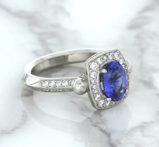 1.56ct Oval Blue Sapphire Ring with Diamond Halo in Platinum