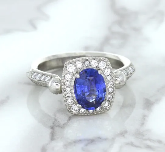 1.56ct Oval Blue Sapphire Ring with Diamond Halo in Platinum
