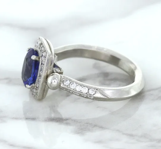 1.56ct Oval Blue Sapphire Ring with Diamond Halo in Platinum