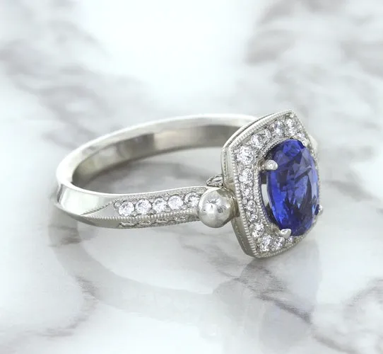 1.56ct Oval Blue Sapphire Ring with Diamond Halo in Platinum