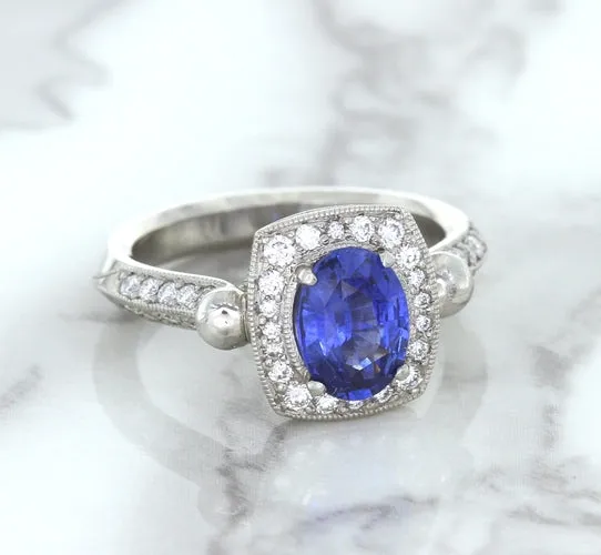 1.56ct Oval Blue Sapphire Ring with Diamond Halo in Platinum
