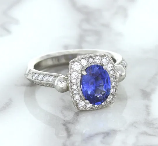 1.56ct Oval Blue Sapphire Ring with Diamond Halo in Platinum