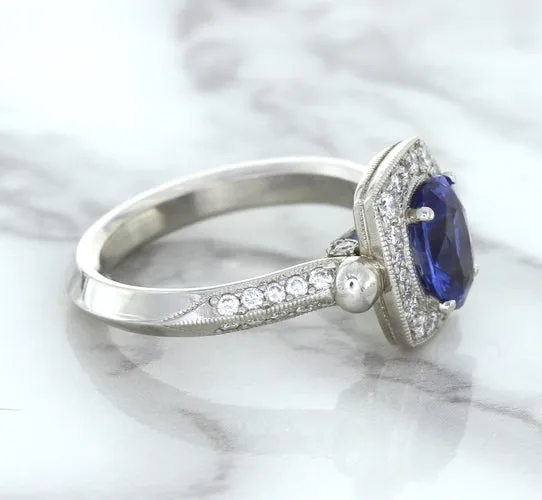1.56ct Oval Blue Sapphire Ring with Diamond Halo in Platinum
