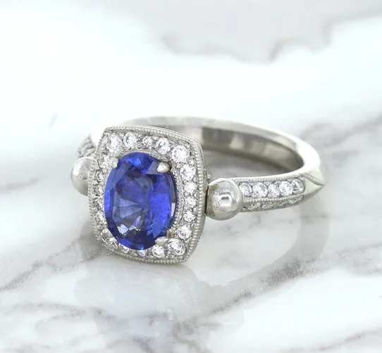 1.56ct Oval Blue Sapphire Ring with Diamond Halo in Platinum
