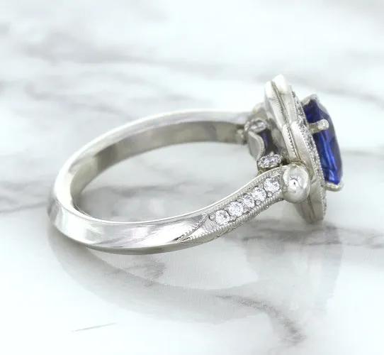 1.56ct Oval Blue Sapphire Ring with Diamond Halo in Platinum
