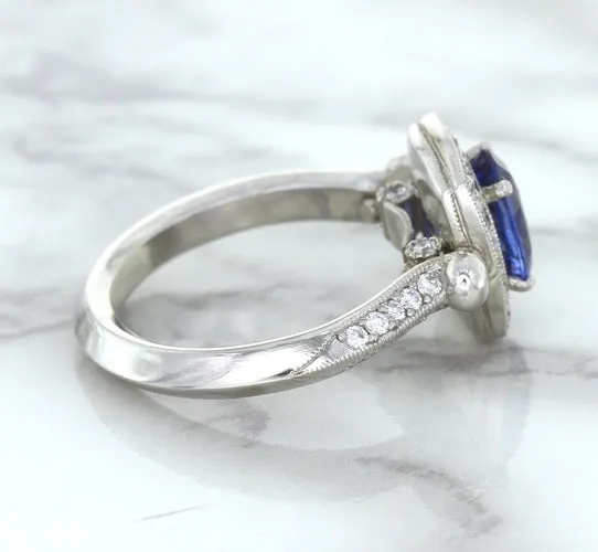 1.56ct Oval Blue Sapphire Ring with Diamond Halo in Platinum
