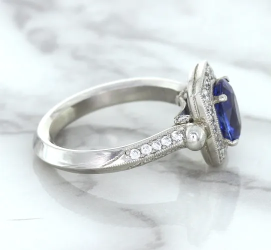 1.56ct Oval Blue Sapphire Ring with Diamond Halo in Platinum