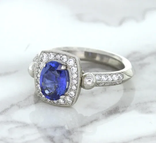1.56ct Oval Blue Sapphire Ring with Diamond Halo in Platinum
