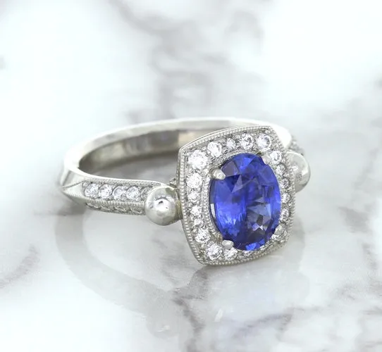 1.56ct Oval Blue Sapphire Ring with Diamond Halo in Platinum