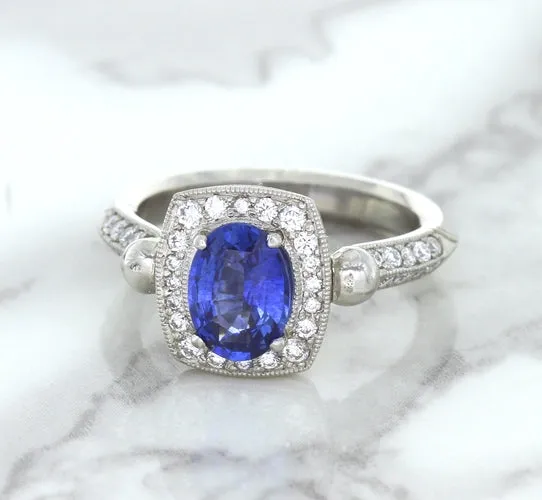 1.56ct Oval Blue Sapphire Ring with Diamond Halo in Platinum