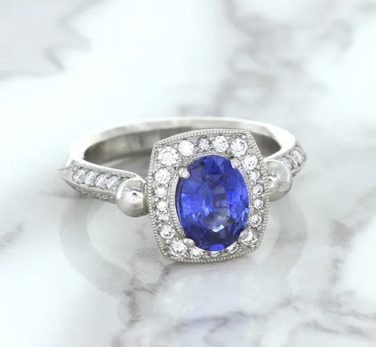 1.56ct Oval Blue Sapphire Ring with Diamond Halo in Platinum