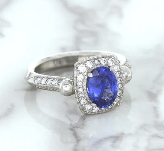 1.56ct Oval Blue Sapphire Ring with Diamond Halo in Platinum