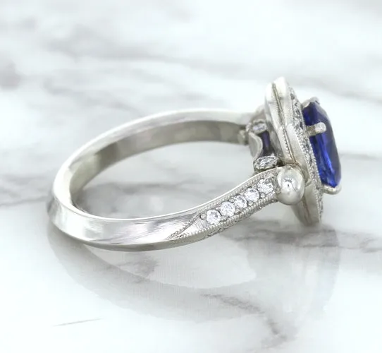 1.56ct Oval Blue Sapphire Ring with Diamond Halo in Platinum