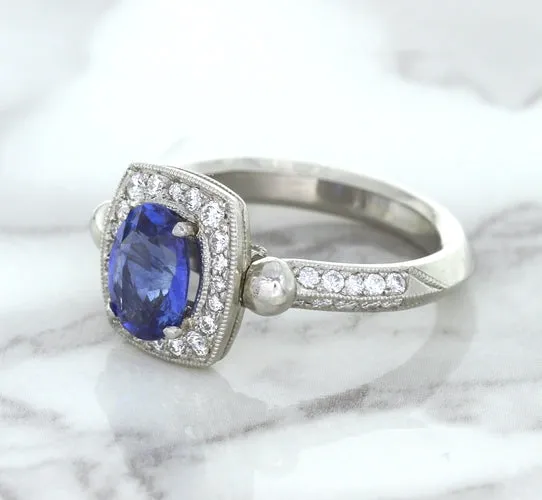 1.56ct Oval Blue Sapphire Ring with Diamond Halo in Platinum