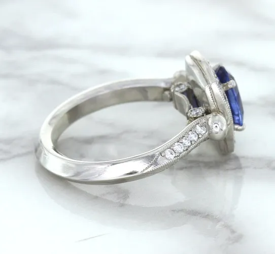 1.56ct Oval Blue Sapphire Ring with Diamond Halo in Platinum