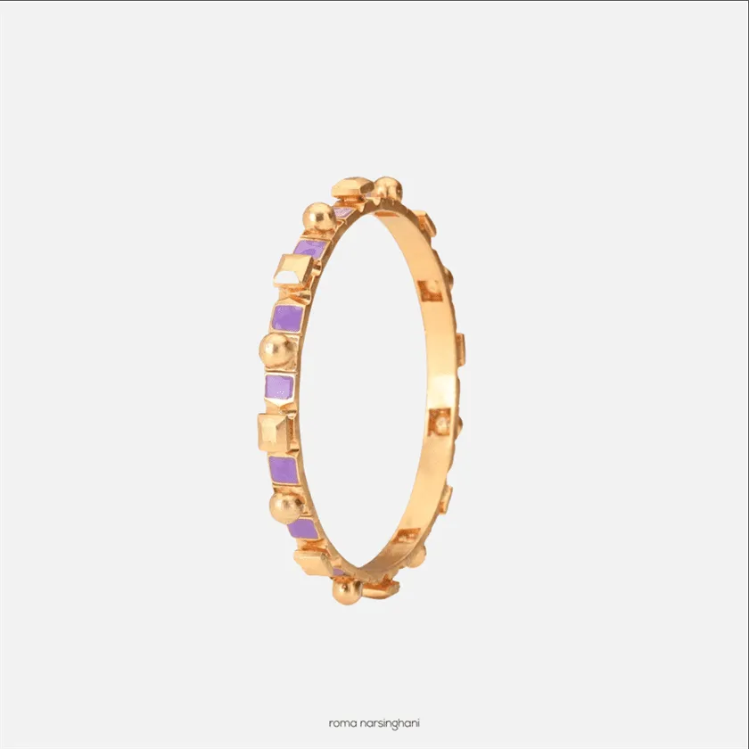 Roma Narsinghani Meena bangle The piece is set in brass, hand enameled with 18KT gold finesse. Each piece is unique and handcrafted by our artisans. RNLOVE01
