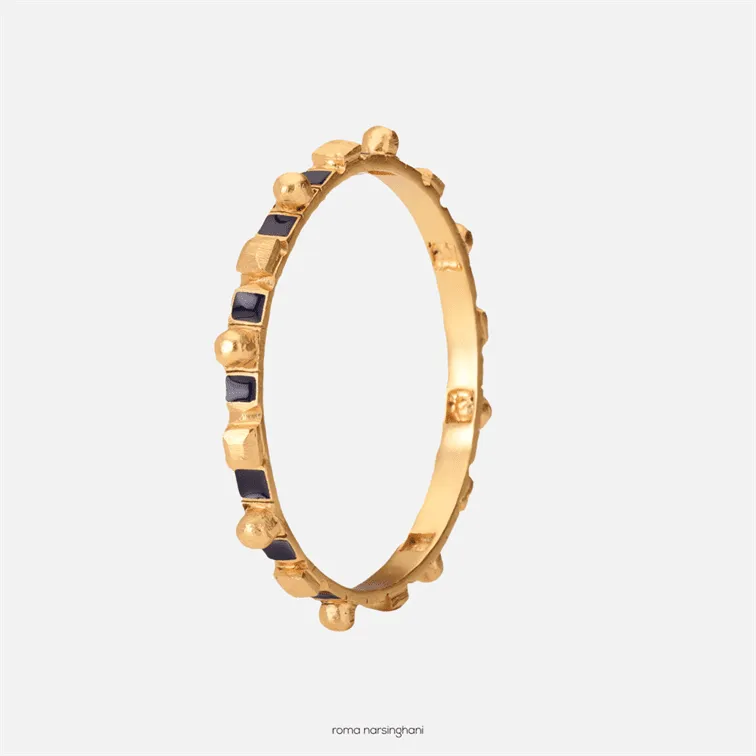 Roma Narsinghani Meena bangle The piece is set in brass, hand enameled with 18KT gold finesse. Each piece is unique and handcrafted by our artisans. RNLOVE01