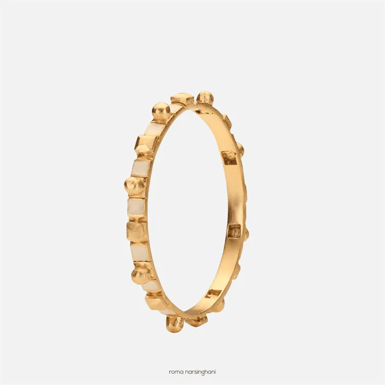 Roma Narsinghani Meena bangle The piece is set in brass, hand enameled with 18KT gold finesse. Each piece is unique and handcrafted by our artisans. RNLOVE01